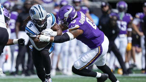 Oct 1, 2023; Charlotte, North Carolina, USA; Carolina Panthers place kicker Eddy Pineiro (4) is tackled by Minnesota Vikings linebacker Marcus Davenport (0) during the second half at Bank of America Stadium.
